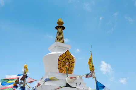 Buddhist stupa with colorful flags on a Annapurna Circuit - most popular turists trek in Himalayan mountain massive in Nepal.の写真素材
