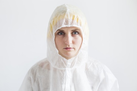 Woman in white protective clothes. Woman scientist or farm worker conceptの写真素材