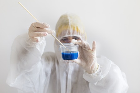Young scientist in white protective suit. Biochemistry and genetics concept. Close upの写真素材