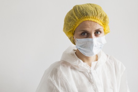 Blonde woman in bio-hazard protective white suitの写真素材