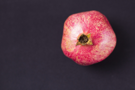 Red tasty pomegranate on dark backgroundの写真素材