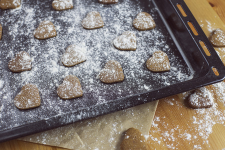 Heart shaped cookies on a baking trayの写真素材