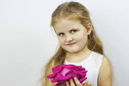 Portrait of a girl with a pink rose flowerの写真素材