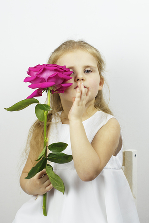 Portrait of a girl with a rose flowerの写真素材