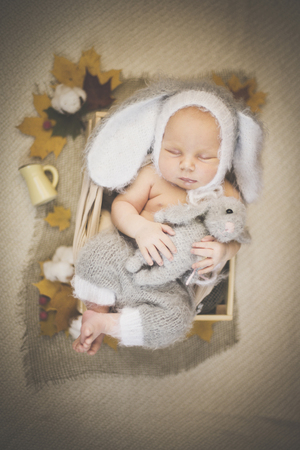 Portrait of a newborn sleeping in a bunny suitの写真素材