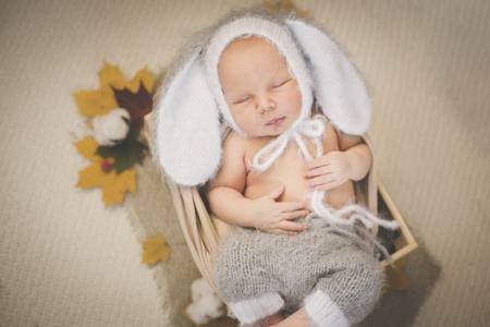 Portrait of a newborn sleeping boy in a boxの写真素材