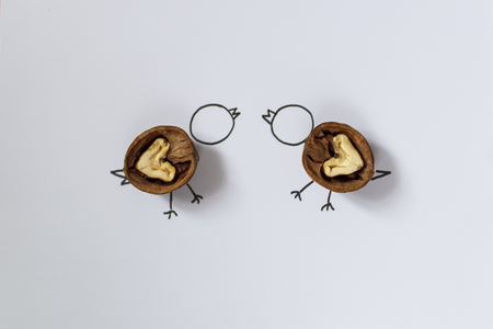 Walnuts in the shape of a heart on a sheet of white paper