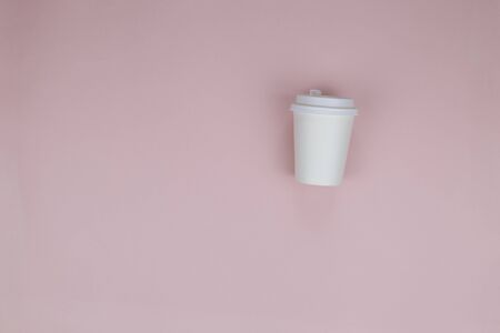 White paper cup on a pink backgroundの写真素材