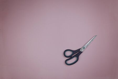 Large sewing scissors on a pink backgroundの写真素材