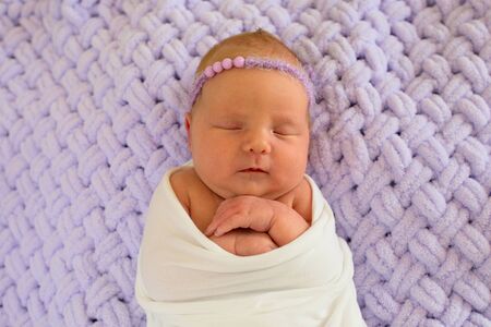 Portrait of a little newborn girl who is sleeping