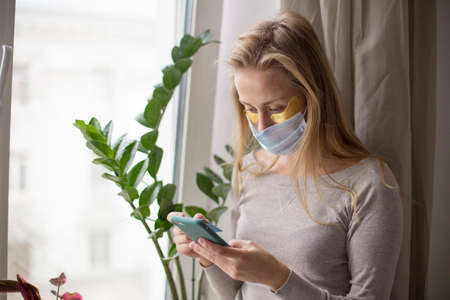A girl during a pandemic makes purchases via the Internet