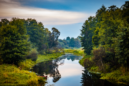 Wild silent Forest river reflection autumn landscape. Autumn forest river water panorama. Forest river reflection in autumnの写真素材