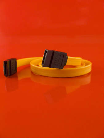 Computer SATA cable on the red backgroundの写真素材