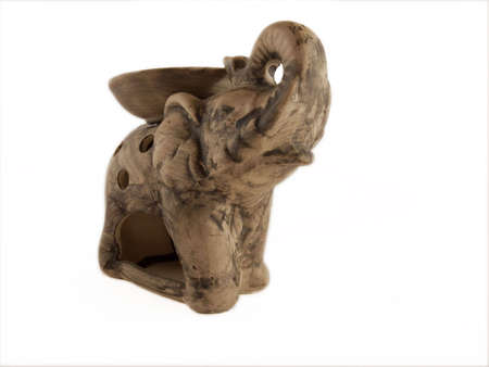 Elephant ceramics candlestick candle fire white backgroundの写真素材