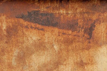 Old rusty metal wall with traces of paint