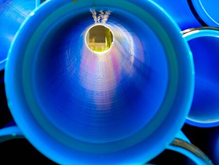 Blue corrugated polypropylene pipes used on the construction site. Double-layer blue PVC water pipes unpacked for installation. Close upの写真素材
