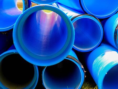Blue corrugated polypropylene pipes used on the construction site. Double-layer blue PVC water pipes unpacked for installation. Close upの写真素材