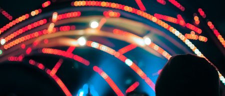 Blurred bokeh Light on a dark background. Defocused Image of an Illuminated outdoor stage area at...