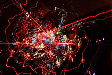 High-speed multidirectional light paths of city lights and car headlights on the road, highway in...