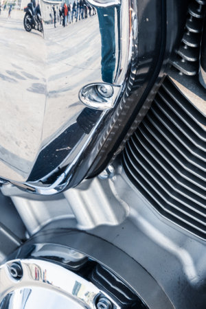 Close-up of a motorcycle engine with chrome details and reflective surfaces.の写真素材
