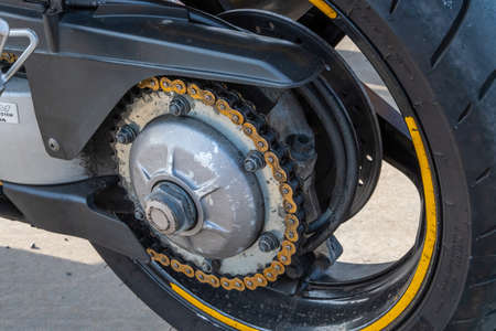Kazan, Russia-September 26, 2020: Close-up of the rear wheel, chain drive and brake system of a motorcycle standing on the asphaltのeditorial素材