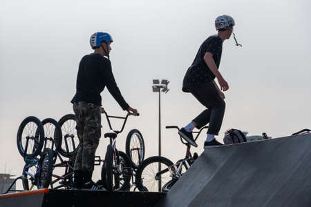 Kazan, Russia-September 26, 2020: Silhouettes of overturned bicycles and riders on the sports ramp.