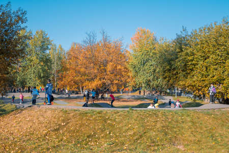 Kazan, Russia - October 03, 2020: Children and teenagers ride scooters and bicycles in the autumn city public parkのeditorial素材