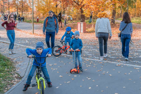Kazan, Russia - October 03, 2020: Children and teenagers ride scooters and bicycles in the city's...