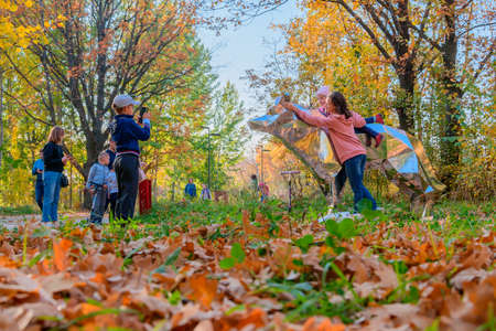 Kazan, Russia - October 03, 2020: Children with their parents take photos and take selfies next to a metal sculpture of an animal in the city's public park on an autumn sunny dayのeditorial素材