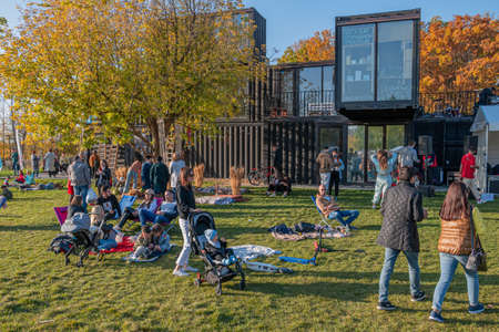 Kazan, Russia - October 03, 2020: Residents walk, relax, sit and lie on the lawn in the city park on a sunny autumn dayのeditorial素材