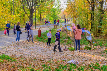 Kazan, Russia - October 03, 2020: Children with their parents are photographed next to a metal sculpture of an animal in the city's public park on an autumn sunny dayのeditorial素材