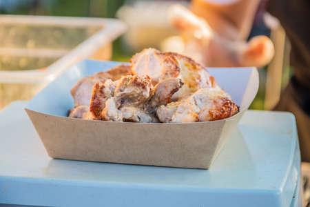 Toasted kebab in a takeaway box on the counter of a street restaurant. Food festival in the city park. Street fast food. Selective focus, shallow depth of field.の写真素材