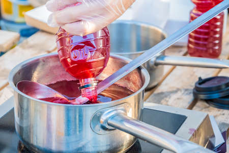 Berry juice made from fresh strawberries or cranberries-a drink to quench your thirst is prepared on the counter of a street vendor.の写真素材