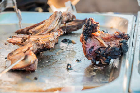 Fried shish kebab on skewers on the counter of a street restaurant. Food festival in the city park. Street fast food. Selective focus, shallow depth of field.の写真素材