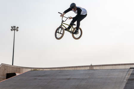 Kazan, Russia - September 26, 2020: A young rider on a BMX bike does tricks in the air. BMX...