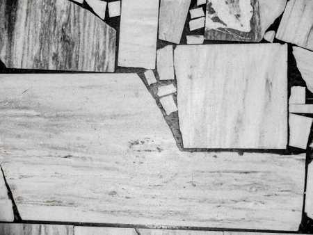 Top view of the old floor, made of various sized pieces of white and gray marble. Abstract black and white monochrome mosaic background.の写真素材