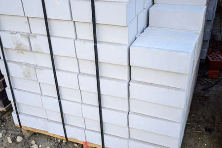 White silicate brick on pallets in a warehouse of building materials.