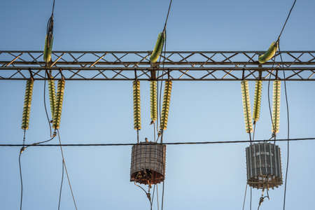 High-voltage power lines with wave trap or high-frequency stopper. Electricity distribution station. High voltage electric transmission tower.の写真素材
