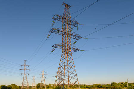 High voltage electric transmission tower. Electrical pylon and high voltage power lines.