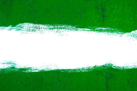 Colored grunge texture background. Abstract texture on an old rusty metal wall. Dirty toned iron battered background with a strip of paint.の写真素材