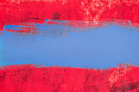 Colored grunge texture background. Abstract texture on an old rusty metal wall. Dirty toned iron battered background with a strip of paint.の写真素材