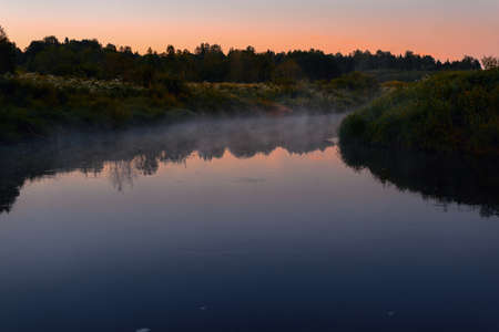 Fog over the river. Summer evening