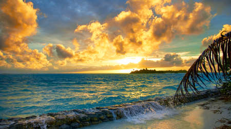 View of the Indian Ocean from the sandy shore. Maldives landscape sunset