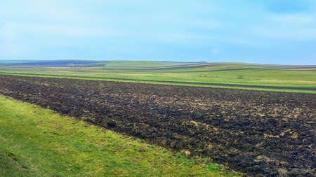 Autumn Caucasus. A strip of plowed field on a sunny day.