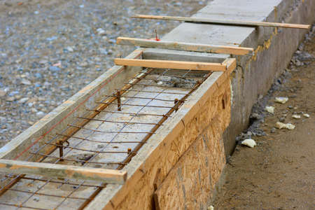 Formwork from slabs for a strip foundation. Strengthening with mesh and reinforcement.の写真素材