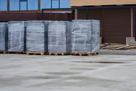 View of film-packed pallets with paving slabs.の写真素材