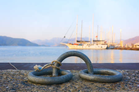 Mooring rings close-up with tied mooring line. View of the bay and marina of Marmaris. Turkeyの写真素材