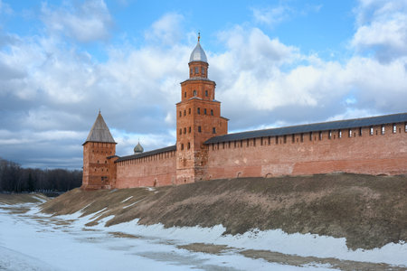 The walls and towers of the red brick fortress on a clear day. Walls and moat of the Novgorod Kremlin in spring.の写真素材