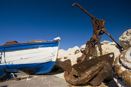 Rusty anchor and an old boat on the Bibinje waterfrontのeditorial素材