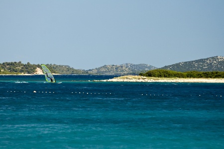 Man surfing on the blue sky near the islandのeditorial素材
